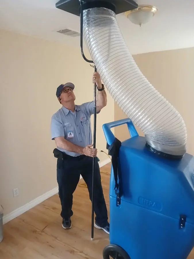 Furnace Tune-Up technician using HEPA equipment in McDonough